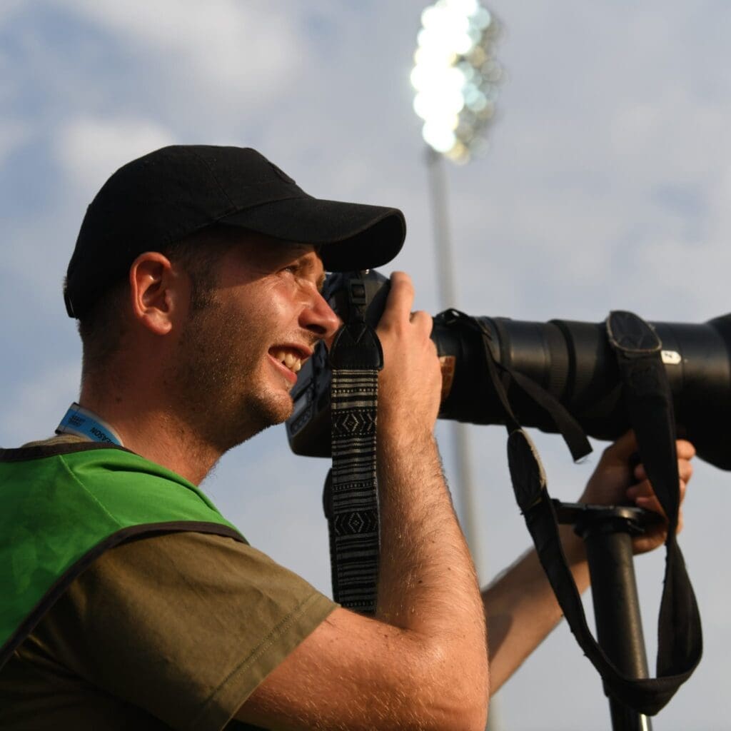 Nathan Stirk smiling while taking photos.